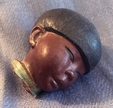 Broken off head of Ellen Jennings Chinese boy with three colors of glaze