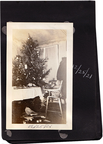 Photo in scrapbook page, with handwritten caption "12/25/21"