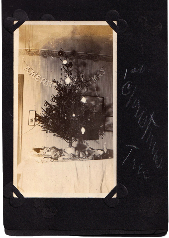 Photo in scrapbook page, with handwritten caption "1st. Christmas Tree"