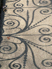 spiral shadows on sidewalk