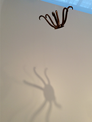 hanging sculpture with six legs, and shadow