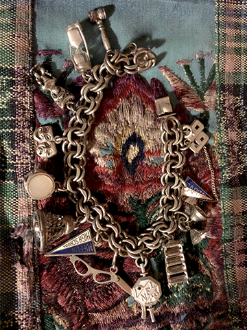 charm bracelet on fabric background
