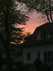 dark photo with windows and an obscured sunset
