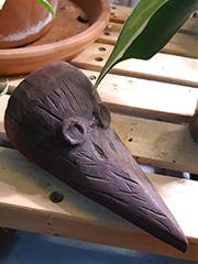 carved bird head with glasses