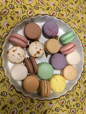 A fancy plate of macaroons on a french tablecloth