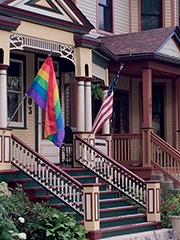 home with rainbow and American flags