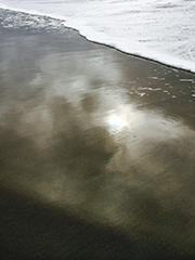 sun reflected in wet sand