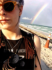 Jane with a rainbow going into the ocean