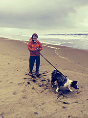 Patricia with Liz's dog by the ocean