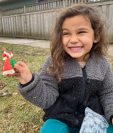 little girl with big smile and santa cookie