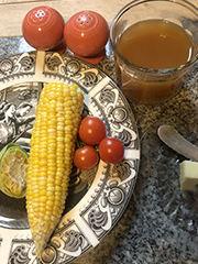corn on the cob, cherry tomatoes, and cider