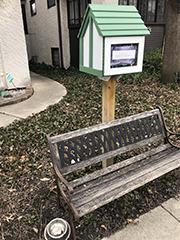 free library with small bench below