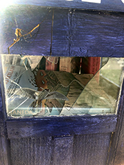 free library with broken glass