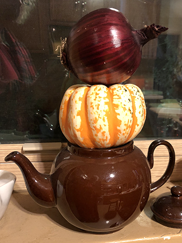 brown Betty tea pot with winter squash and a red onion