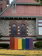 doors in front of church painted in rainbow colors