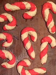 candy cane cookies on an antique bread board