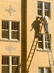 window washer on very tall ladder