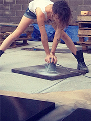 young woman in boots grinding flooring
