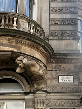 George Square sign on building with beautiful sculpture