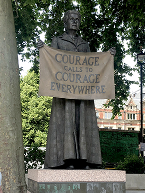 Bronce sculpture of woman holding banner "Courage Calls to Courage Everywhere"