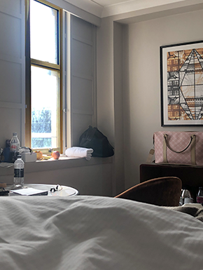 View from bed with window and pink bag