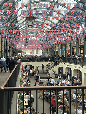 Glass covered Covent Garden with British flags over café