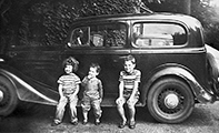 vintage car with kids on running board