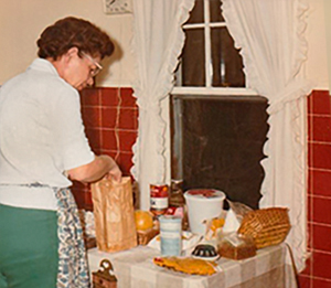 Woman cooking in red and white kitchen