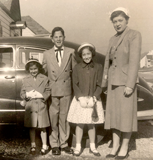 family in front of car