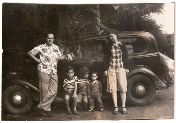 family in front of car