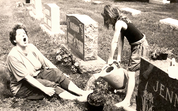 Jane pouring water on Susan's feet while we planted flowers at the grave.