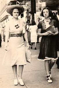 Woman and teenage girl on the street in the 1940s.