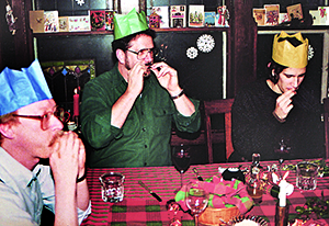 Marty, Michael, and Matt at Christmas dinner playing mini harmonicas