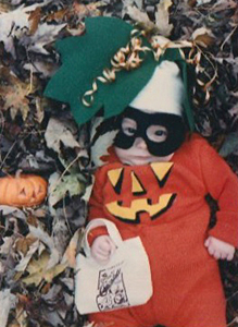 Baby Jane as pumpkin lying in leaves