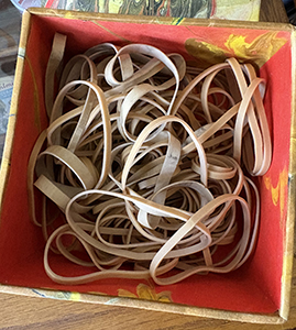 rubber bands in marbled paper covered box