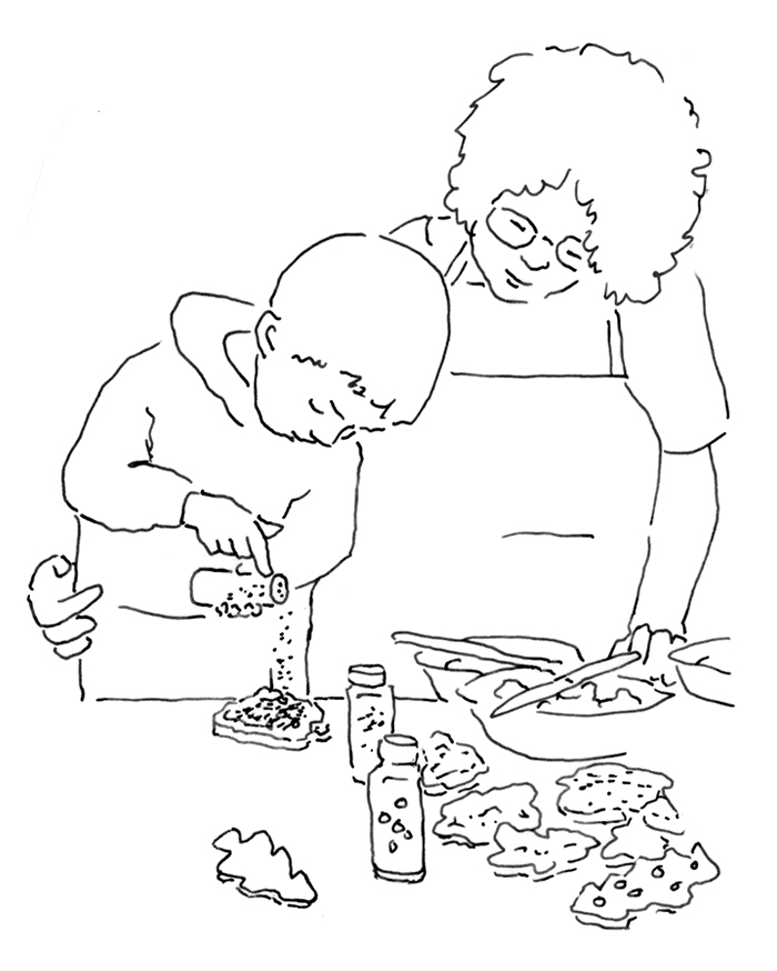Woman and chld decorating cookies