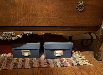 boxes of photos under bed